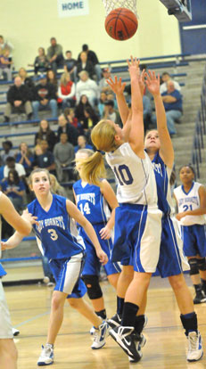 Bryant White's Lauren Lessenberry (10) puts up a shot over Bryant's Blue's Sarah Kennedy and Bethany Hutchison (3). (Photo by Kevin Nagle)