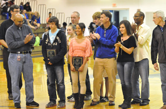 Connor Wilson and Melinda Murdock, supported by their parents, receive Athlete of the Month plaques from Sykes Representative Calvin Naylor. (Photo by Kevin Nagle)