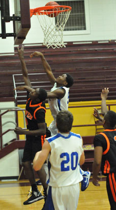 Kris Croom gets a shot up off the glass over a Malvern defender. (Photo by Kevin Nagle)