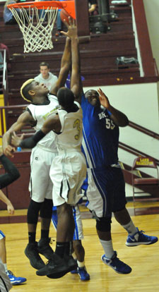 Cameron Murray (55) tries to get a shot up over a pair of Hot Springs defenders. (Photo by Kevin Nagle)