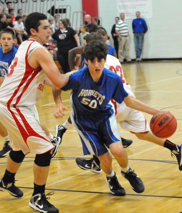 Bryant White's Kyle Sahr (50) drives around a Cabot South defender. (Photo by Kevin Nagle)