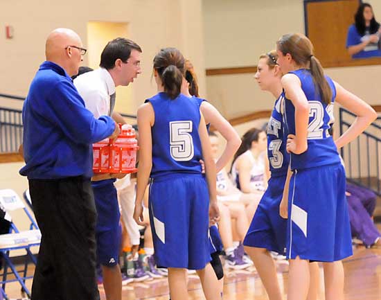 Bryant coaches Steve Wright, left, and Nathan Castaldi instruct the Lady Hornets freshmen during a timeout in Thursday's game. (Photo by Kevin Nagle)