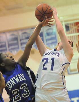 Courtney Davidson (21) reaches for a rebound. (Photo by Kevin Nagle)