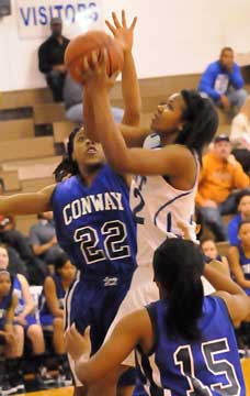 Bryant's Taneasha Rhode goes up for a shot as she's contested by Conway's Enjinae Chambers (22). (Photo by Kevin Nagle)