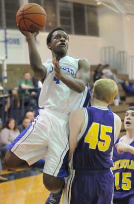 K.J. Hill (4) shoots over Catholic's Kirk Hutchins (45). (Photo by Kevin Nagle)