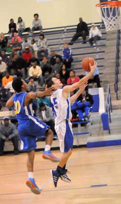 Brandan Warner goes to the hole in front of North Little Rock's Kahlil Hill. (Photo by Kevin Nagle)