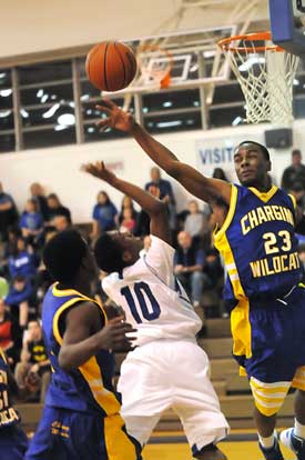 North Little Rock's Tyree's Hollister (23) tries to block a shot by Bryant's Anthony Black. (Photo by Kevin Nagle)