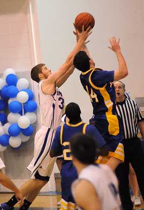 Bryant's Quinton Moto and North Little Rock's Matt Terry contend for a rebound. (Photo by Kevin Nagle)