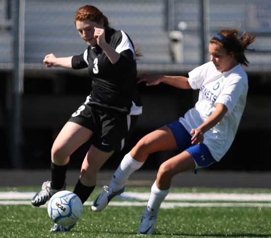 Bryant's Katie Barrington battles with an opponent for a loose ball. (Photo by Rick Nation)