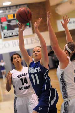 Logan Davis (11) fires up a shot between two Mount St. Mary defenders. (Photo by Kevin Nagle)