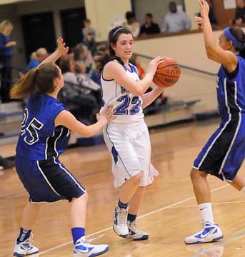 Mallory Curry (22) tries to protect the ball from a double-team. (Photo by Kevin Nagle)