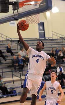 K.J. Hill (4) starts a layup in front of teammate Brandan Warner. (Photo by Kevin Nagle)