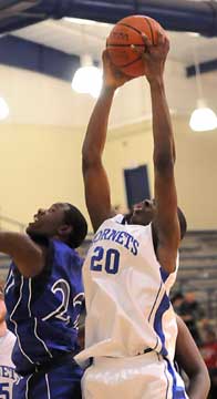 J.C. Newborn (20) skies for a rebound over Conway Blue's Marquis Clemmons. (Photo by Kevin Nagle)