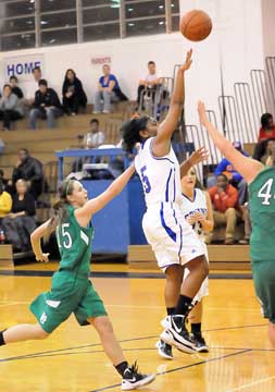 Dezerea Duckworth (5) tosses up a shot on the move in front of Van Buren's Britney Campbell (15) and Bryant's Aubree Allen. (Photo by Kevin Nagle)