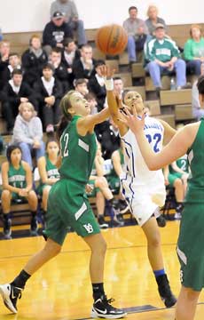 Kiara Moore (22) flips up a shot past Paige Beckner. (Photo by Kevin Nagle)