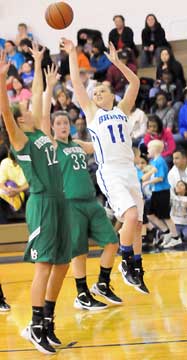 Bryant's Logan Davis (11) puts up a shot in front of Van Buren's Paige Beckner (12) and Mallory Brown (33). (Photo by Kevin Nagle)