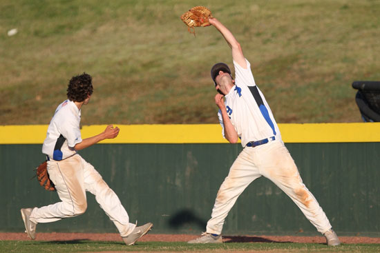 Bryant first baseman Dylan Cross hauls in a foul pop as teammate Ozzie Hurt scampers to cover first. (Photo by Rick Nation)