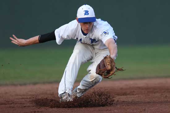 Jordan Taylor backhands a ball at shortstop. (Photo by Rick Nation)