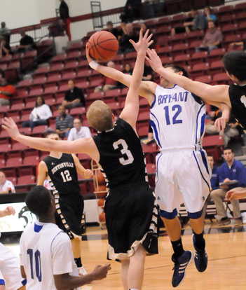 Brantley Cozart (12) takes a shot to the face as he hauls down a rebound in front of Bentonville's Austin Haggard (3). (Photo by Kevin Nagle)