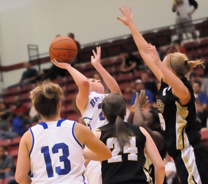 Bryant's Courtney Davidson tries to get a shot up over Bentonville's Julia Garrard in front of Niki Wilson (24) and Callie Hogancamp (13). (Photo by Kevin Nagle)