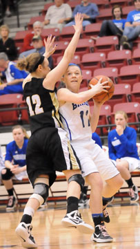 Bryant's Logan Davis (11) tries to find room for a pass around Bentonville's Taylor Lee. (Photo by Kevin Nagle)