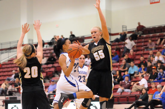 Bryant's Kiara Moore drives to the basket against Bentonville's Julia Garrard. (Photo by Kevin Nagle)