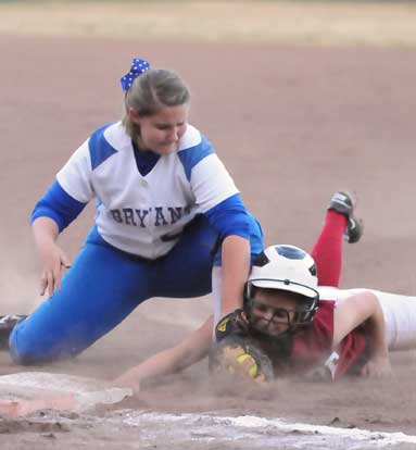 Bryant first baseman Kaley Coppock applies a tag on a pick-off play. (Photo by Kevin Nagle)