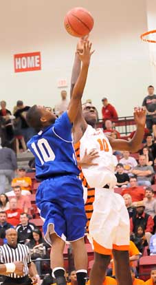Bryant's Anthony Black (10) tries to loft a shot over Little Rock Hall's Bobby Portis. (Photo by Kevin Nagle)