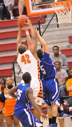 Little Rock Hall's Roy Owens (42) goes up over Bryant's Jordan Griffin (5) and Greyson Giles for a rebound. (Photo by Kevin Nagle)