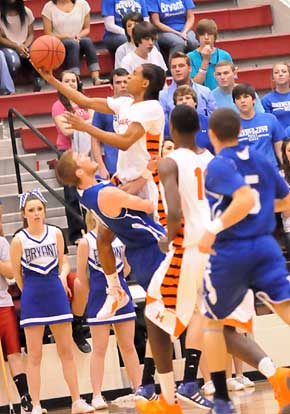 Bryant's Quinton Motto takes a charge on a drive by Hall's Daunde Barete. (Photo by Kevin Nagle)