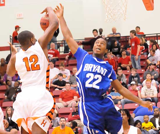 Bryant's Marcus Wilson (22) contends with Little Rock Hall's Anfernee Floyd (12) for a rebound. (Photo by Kevin Nagle)