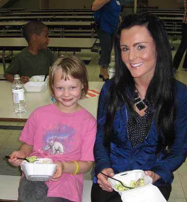 Araina Camron enjoys some green eggs and ham with BES assistant principal Jordan Eason.