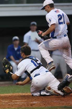 Catcher Hayden Lessenberry takes a throw at the plate as Tyler Nelson (21) tries to avoid a collision. (Photo by Rick Nation)