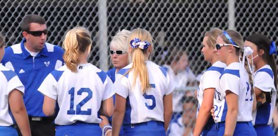 Bryant head coach Debbie Clark and assistant Nathan Castaldi gather the Lady Hornets before an inning. (Photo by Kevin Nagle)