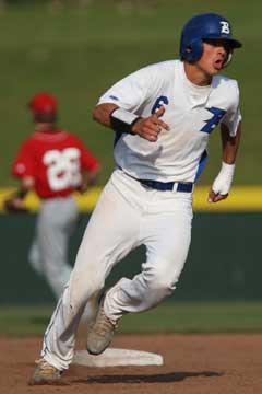 Chase Tucker rounds third and heads for home. (Photo by Rick Nation)