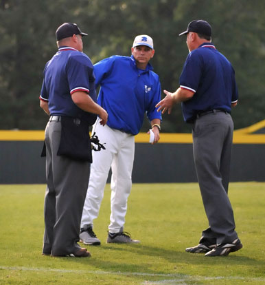 Bryant head coach Kirk Bock discusses a call with the umpires. (Photo by Kevin Nagle)