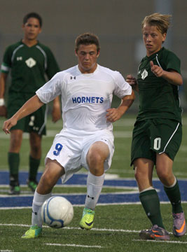 Bryant's Forrest Fowler (9) controls the ball. (Photo by Rick Nation)