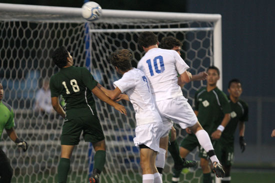 Alex Rowlan (10) and Josh Lowery (7) charge the net. (Photo by Rick Nation)