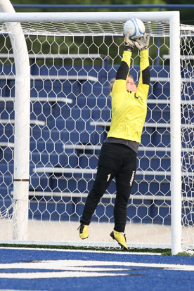 Keeper Kaitlyn Miller reaches high for a Van Buren shot. (Photo by Rick Nation)