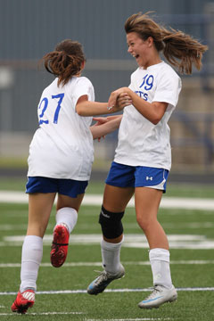 Kara Taylor (27) and Emily Pierce (19) celebrate Taylor's goal. (Photo by Rick Nation)