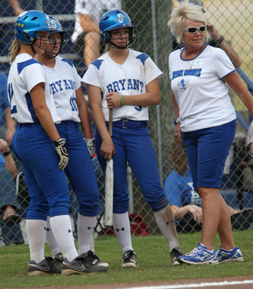 McKenzie Rice, 12, Cassidy Wilson, 10, and Jenna Bruick, 5, meet with Bryant head coach Debbie Clark during a timeout in Thursday's game against Van Buren. (Photo by Rick Nation)