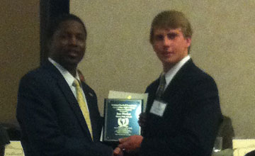 Jace Denker, right, accepts his plaque at the ceremony on Saturday.