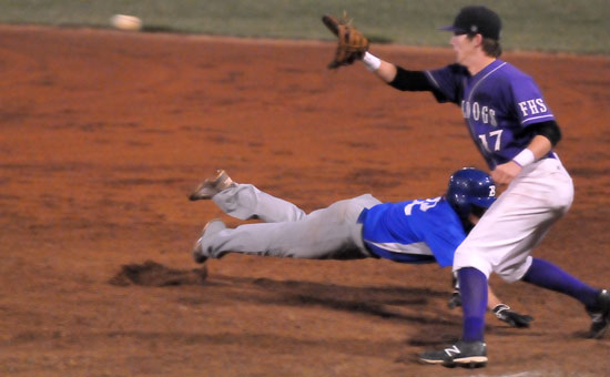 Bryant's Trevor Ezell dives back into first on a pick-off play. (Photo by Kevin Nagle)