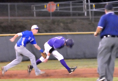 Bryant's Jordan Taylor (14) tags out Fayetteville's Cade Waller at the end of a rundown. (Photo by Kevin Nagle)