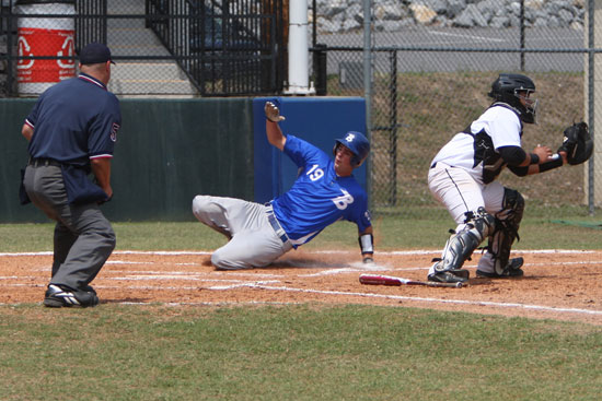 Dylan Cross slides home to score Bryant's first run Monday. (Photo by Rick Nation)