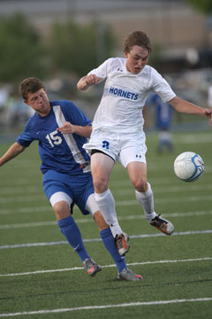 Chase Stuart (8) contends with a Conway defender for possession. (Photo by Rick Nation)