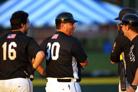 Black Sox manager Darren Hurt (30) shares a light moment with Landon Pickett (16) and assistant coach Brady Butler. (Photo by Rick Nation)