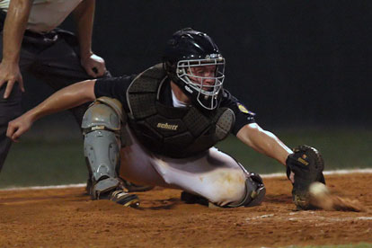 Bryant catcher Zach Graddy short-hops a pitch. (Photo by Rick Nation)