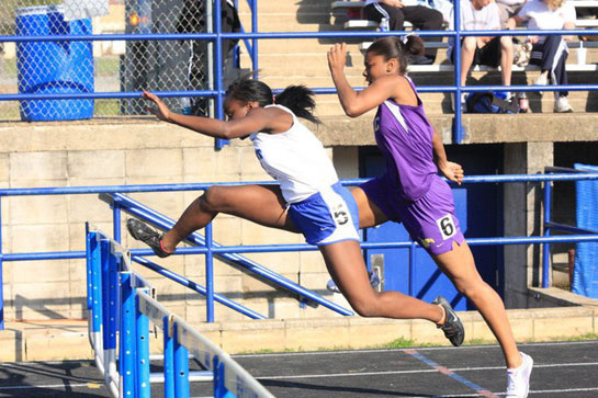 Alexis Royal clears a hurdle at the Hornet Relays earlier this year. (Photo courtesy of Steven Murdock)