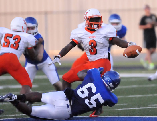 Bryant's Kordell Boykins (65) latches onto Little Rock Hall running back Tony Glover. (Photo by Kevin Nagle)